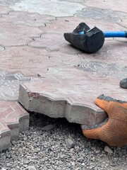 close up of laying paving stones the hands of a master in the process of work