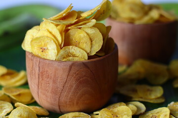Golden plantain chips in rustic bowl. Tropical Kerala snack, good for tradition and snacking themes