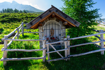 Little White and Wooden Chapel with a white Fence. Hiking trough the Hirzer Alm