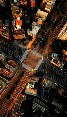 Obraz premium Aerial Cityscape Night View: Illuminated Urban Structures and Traffic Flow in a Modern Abstract Artistic Style