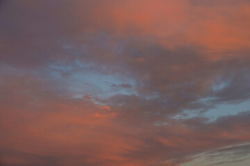 Beautiful sunset evening sky. Cloudy red pink celestial background