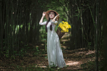 Beautiful Vietnamese Woman in Traditional White &Aacute;o D&agrave;i with Yellow Flower Basket