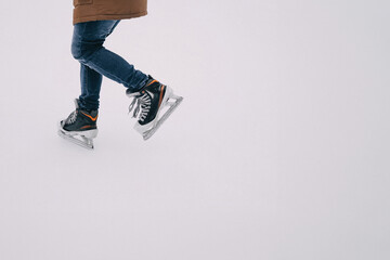 A person gracefully ice skating indoors during winter, showcasing skill and balance on the rink