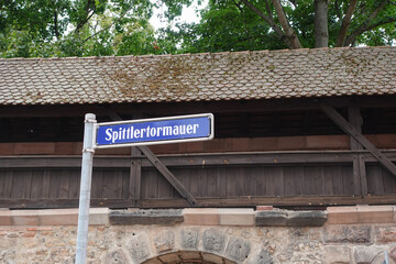 Street Sign Spittlertormauer With Medieval Wall In Nuremberg, Germany. 
