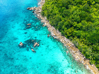 Seychelles aerial view, La Digue and Praslin. Sharp granite rock formations, transparent turquoise waters, and tropical shoreline. Exotic landscape.