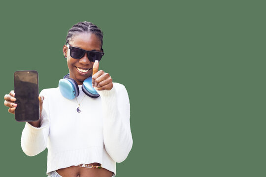 Young Black Woman with Smartphone and Thumbs Up Gesture