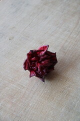 rose flower on a wooden background in large print,