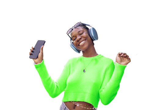 Joyful woman listening to music and dancing with phone