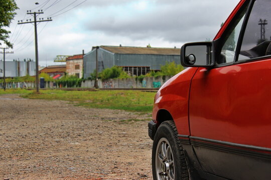 red opel corsa close-up against the background of a country road