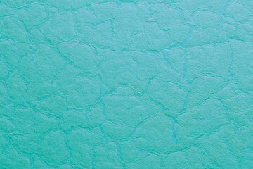 Obraz premium Turquoise wallpaper with a crumpled and smoothed paper texture