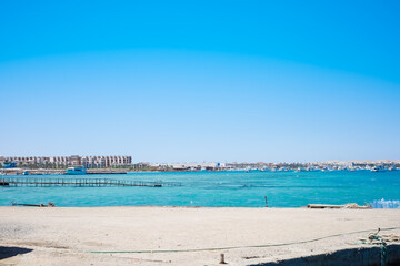Fototapeta premium Coastal cityscape with boats and clear sky