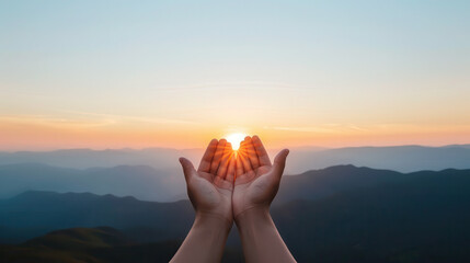 A hand is raised in the air with the sun shining on it