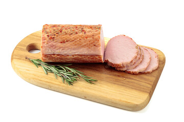 Sliced ham with rosemary on a cutting board.