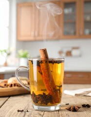 Warm spiced drink garnished with cinnamon and cloves on a rustic wooden table