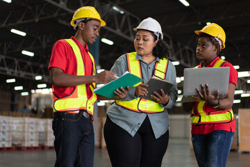 African worker reporting work to manager. Group of logistic staff discussing and working at warehouse factory. Checking stock prepare for shipping delivery.