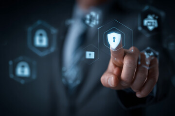 Businessman touching shield icon on virtual screen for cybersecurity concept