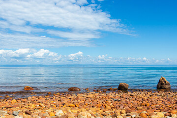 Lake Baikal. Coastal Serenity Pebble Beach Under a Clear Blue Sky