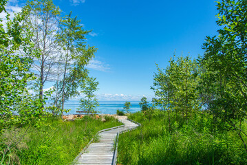 Wooden Boardwalk Path to Lake Baikal Under Blue Sky