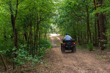 Person Riding an ATV on a Forest Path in Nowy Lubiel, Poland