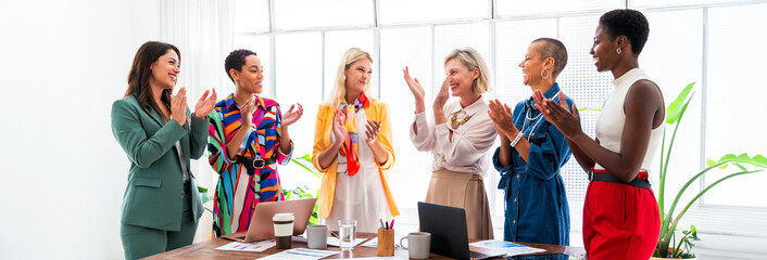 Obraz na płótnie Canvas Group of businesswomen meeting in the office - Multiethnic team of corporate business women working in a creative start-up company office