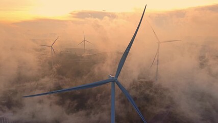 Group of wind turbines against sunset with fog or clouds. Concept green renewable energy of Vietnam technology. - Powered by Adobe