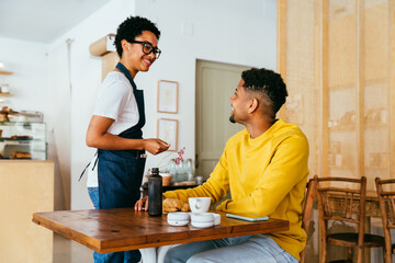 Barista working in a bar cafeteria