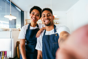 Barista and waiter working in a bar cafeteria shop