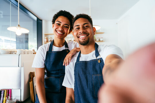 Barista and waiter working in a bar cafeteria shop