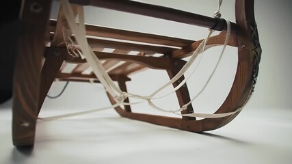 Vintage Wooden Sled with Curved Runners And Rope Detail Set Against A Neutral Background With Diffused Lighting For - Powered by Adobe