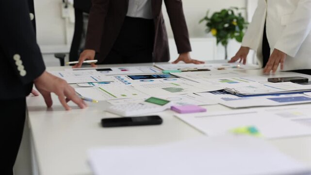 Business team analyzing data and developing strategies in office meeting.