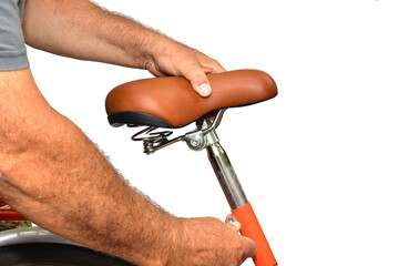 Manually adjusting the height of the bicycle seat.