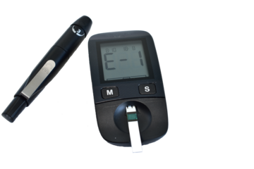 Glucometer and skin lancing device on white background.