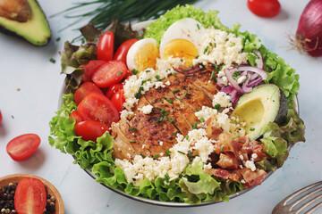 A bowl with cobb salad, traditional American dish