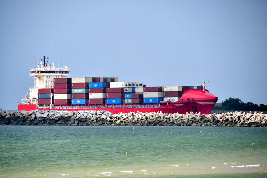 Klaipeda, Lithuania - July 20, 2025: Large loaded cargo container ship approaching port of Klaipeda in Lithuania