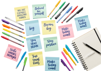 Vibrant Sticky Notes with Inspirational Messages and Colorful Pens for Daily Motivation and Goal Setting on a Clean White Background