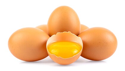 Stacked brown eggs, one cracked open, yolk visible