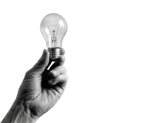 A grayscale image shows a hand holding a lightbulb