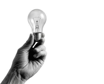 A grayscale image shows a hand holding a lightbulb