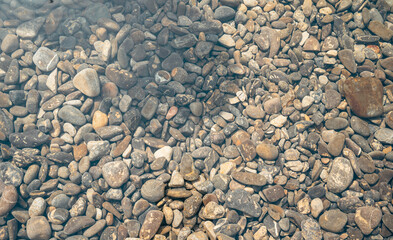 Colorful Pebbles in a Riverbed Background