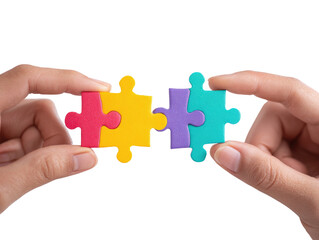 Two hands hold three colorful puzzle pieces together