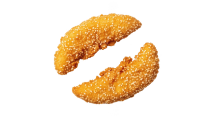 Two golden brown sesame seed crusted chicken tenders on background seeds
