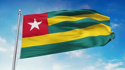 Togo flag waving proudly against a clear blue sky, symbolizing national pride and freedom.