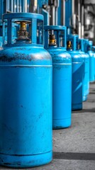 Awesome photo of lineup of bright blue compressed gas cylinders, industrial, medical gases.