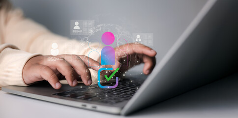 HR manager typing on laptop with digital employee profile and verification icon, concept of recruitment, workforce management, and online human resources system.