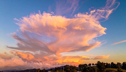 Obraz premium Dramatic Sunset Cloudscape Over Rolling Hills and Lush Green Trees