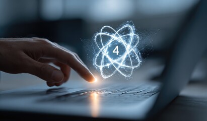 Hand hovering over a glowing atom symbol on a laptop keyboard