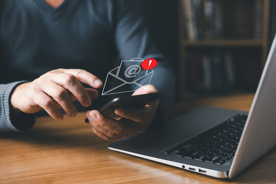 person using a smartphone receives a digital email notification with an alert symbol, representing spam, phishing, fake messages, scams, hacked accounts, malware, red warning alert, and virus threats.