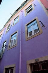 building with a purple painted facade, typical of the Alfama district in Lisbon, Portugal