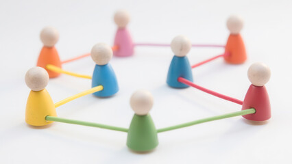 Fototapeta premium Colorful Wooden Figures Connected by Strings Representing Community and Collaboration