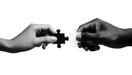Two hands, one light-toned and one dark-toned, join a jigsaw puzzle piece